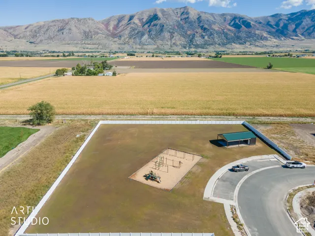 Expansive outdoor amenity space featuring a playground structure and a covered picnic area