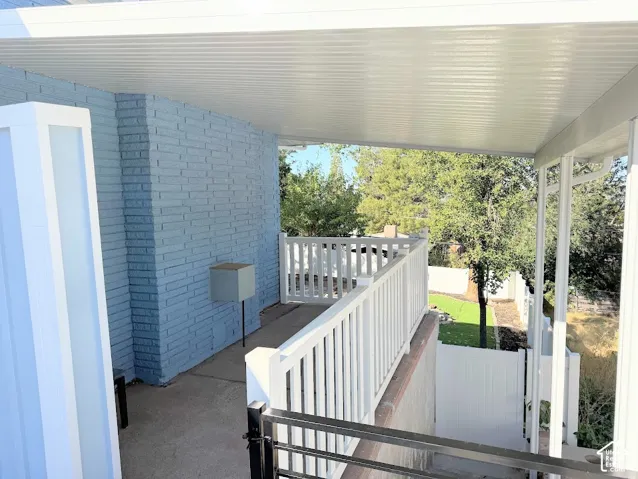 Side Covered outdoor patio/Stairwell for basement tenant