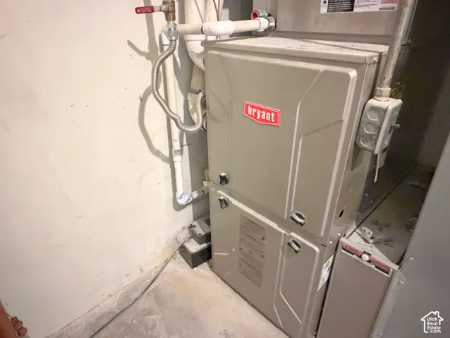 Bryant brand furnace with visible piping and electrical conduit