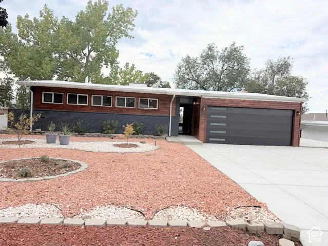 Contemporary exterior with dark brick accents and wood-finish siding