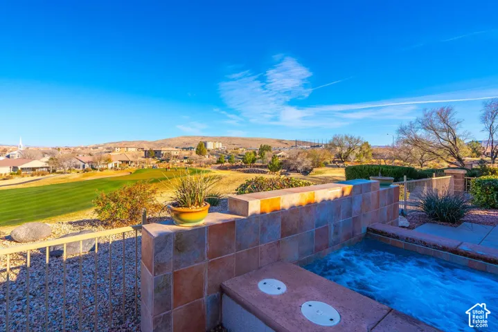 Outdoor spa featuring a tiled surround and water feature