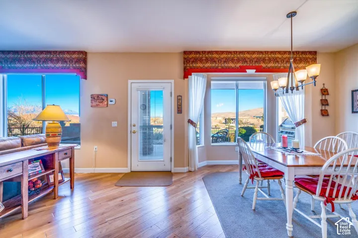Wood-finish flooring throughout, large windows, and a glass-paneled exterior door