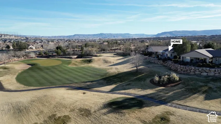 Golf course frontage with a manicured green and desert landscaping