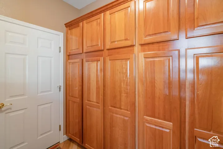 Built-in wood-finish cabinetry with crown molding and panel doors