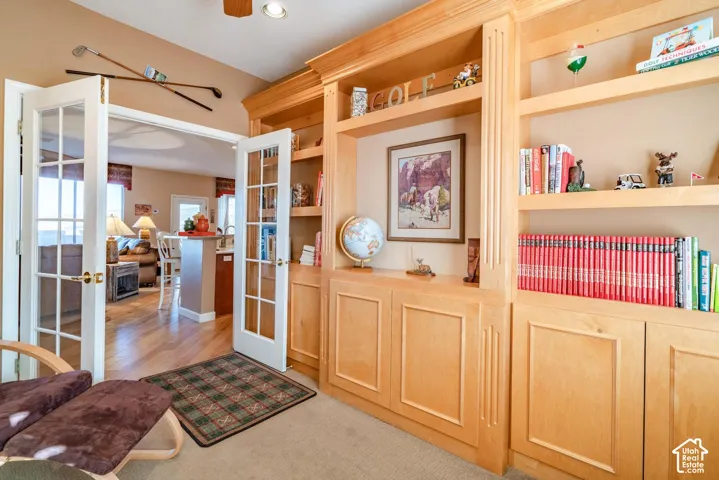 Built-in light-tone wood cabinetry with integrated shelving and lower storage