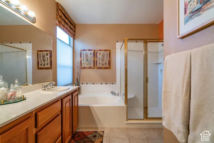 Integrated vanity with wood cabinetry and a white countertop, featuring an undermount sink