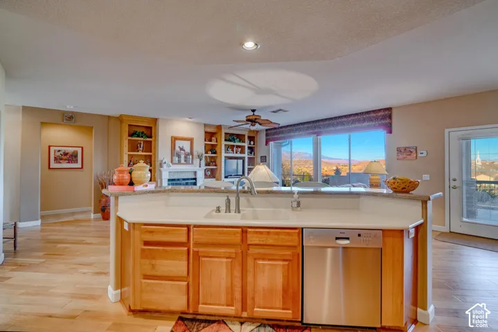 Kitchen island with an undermount sink and stainless steel dishwasher