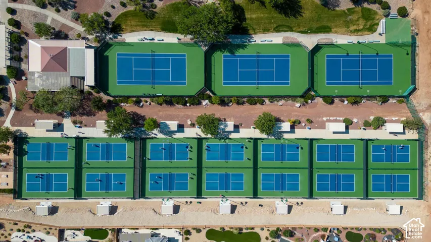 Multiple tennis courts, dedicated pickleball courts, and a central clubhouse with shaded areas