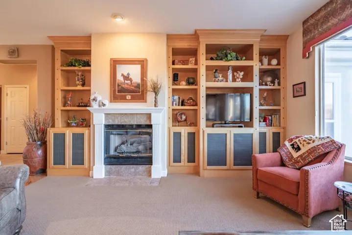 Built-in maple cabinetry, integrated shelving, and a gas fireplace with a tiled surround