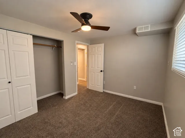 Neutral-toned walls complement the textured carpet flooring
