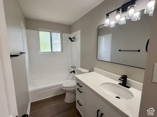 White vanity with black hardware, white countertop, and an undermount sink