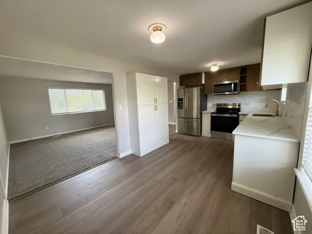 Wood-finish flooring throughout the kitchen area