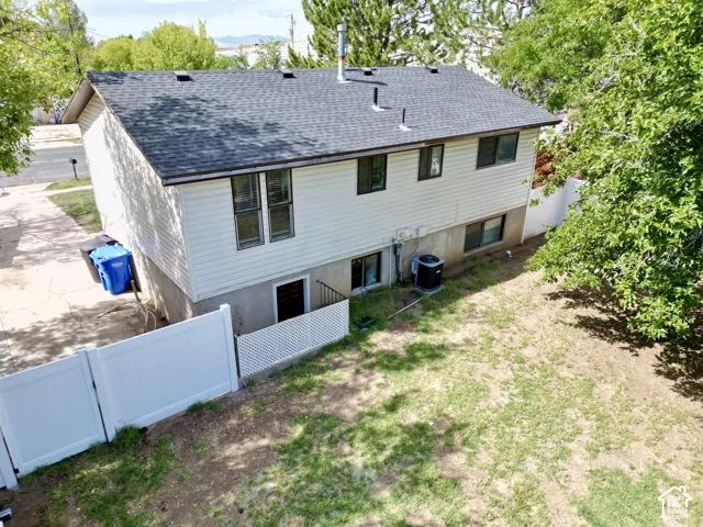 New Roof!  Private backyard with a white privacy fence, mature trees, and a lower-level walkout access