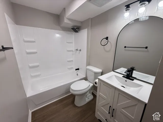 Modern bathroom featuring a white vanity with textured doors, a rectangular undermount sink, and a black-finish faucet
