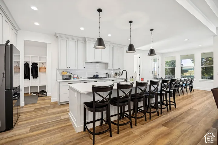 Spacious kitchen with large island, quartz countertops.
