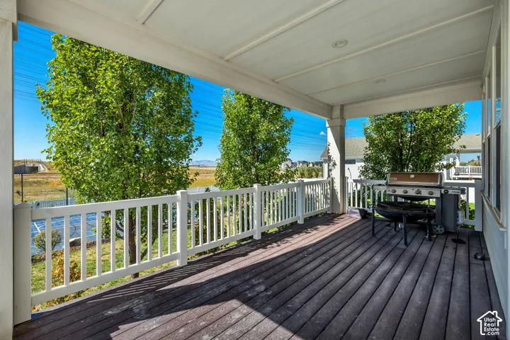 Covered outdoor deck with composite decking and white railings