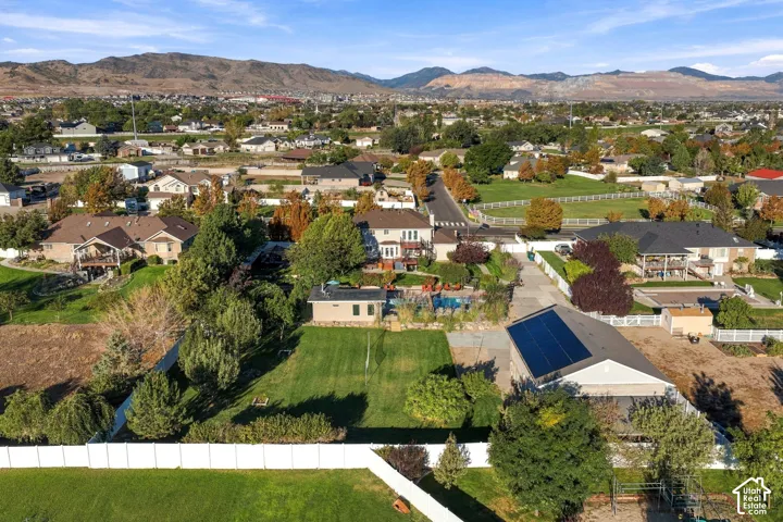 Expansive property featuring a large manicured lawn, a swimming pool, and a building with solar panels
