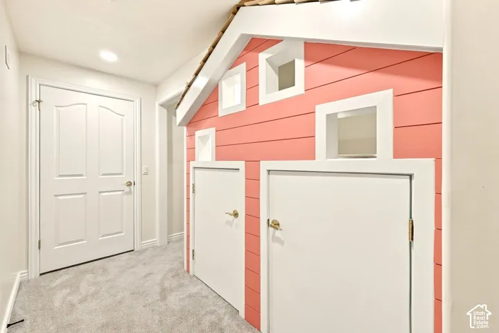 Carpeted flooring, recessed lighting, and a decorative interior playhouse structure with two doors