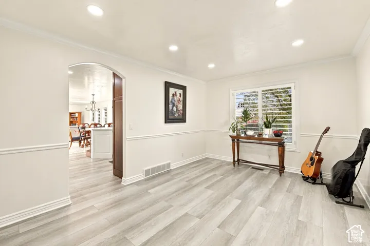 Recessed lighting, crown molding, and two-tone wall treatment