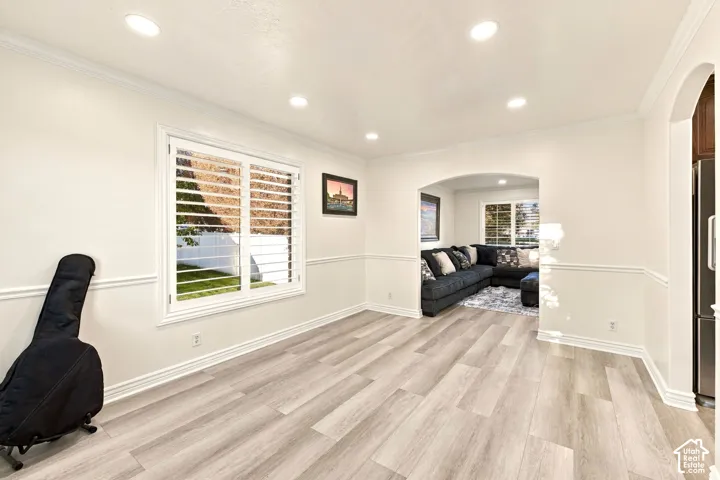 Recessed lighting illuminates wood-finish flooring