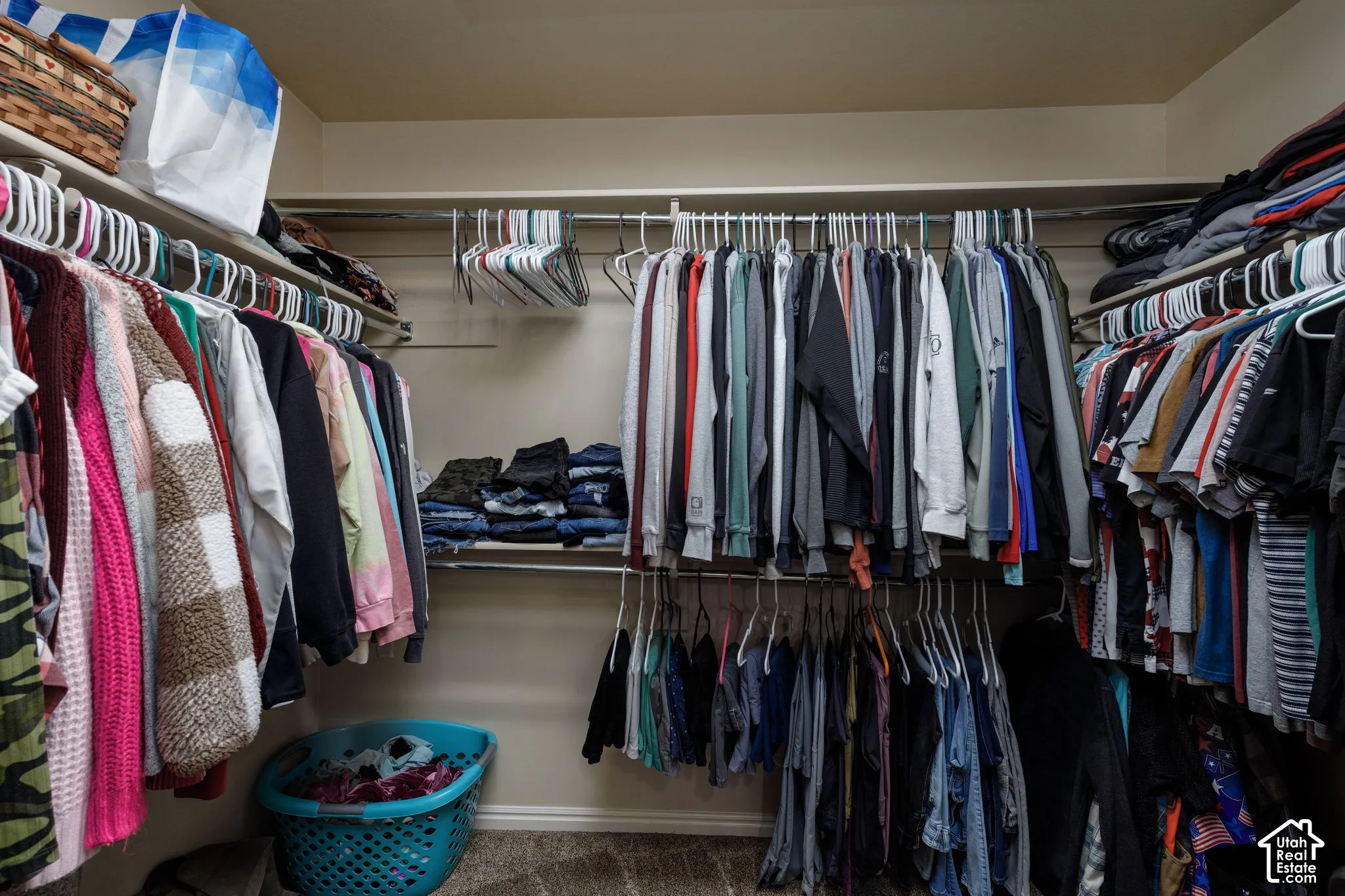 Built-in shelving with multiple hanging rods and wall-mounted storage