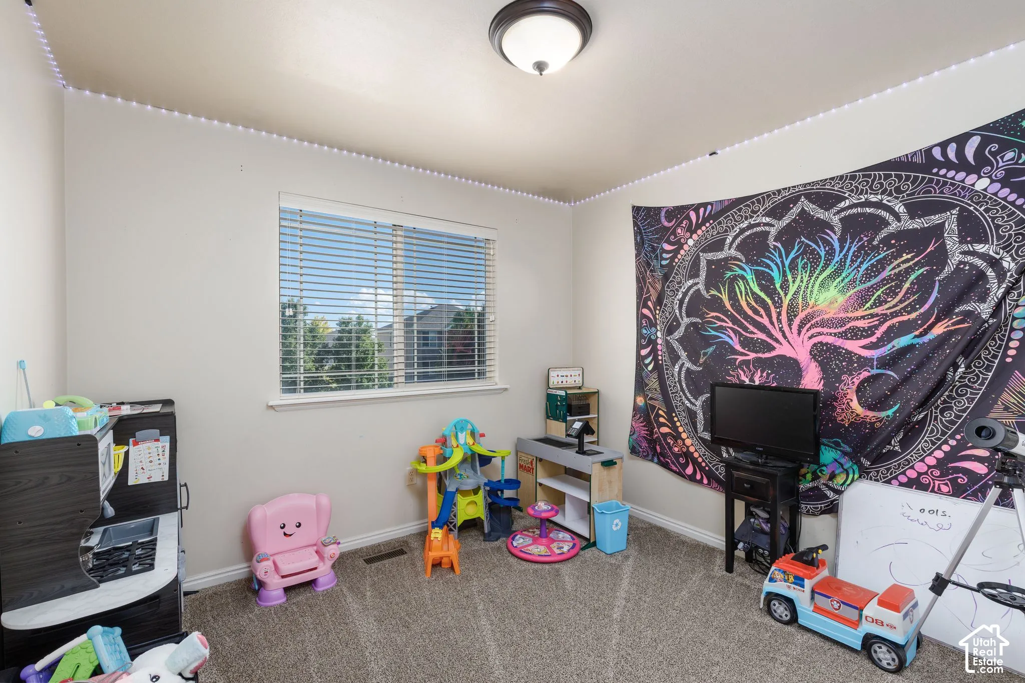 Recessed window with horizontal blinds, overhead flush mount lighting, and carpeted flooring