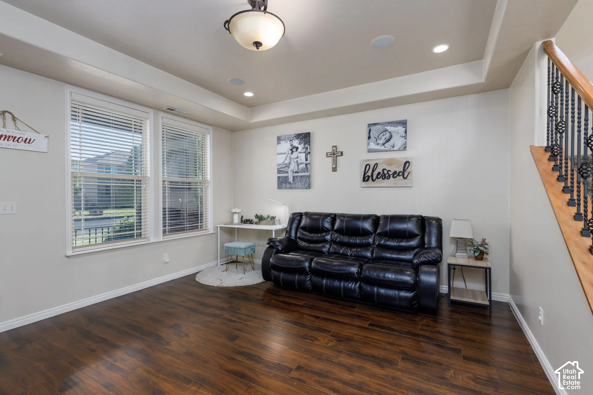 Wood-finish flooring, recessed lighting, and a tray ceiling