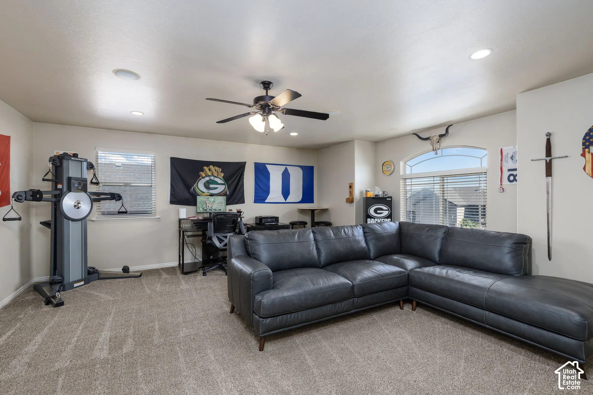 Recessed lighting, ceiling fan, arched window, and neutral wall tones