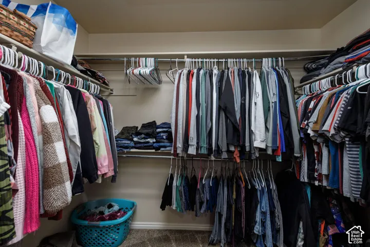Built-in shelving with multiple hanging rods and wall-mounted storage