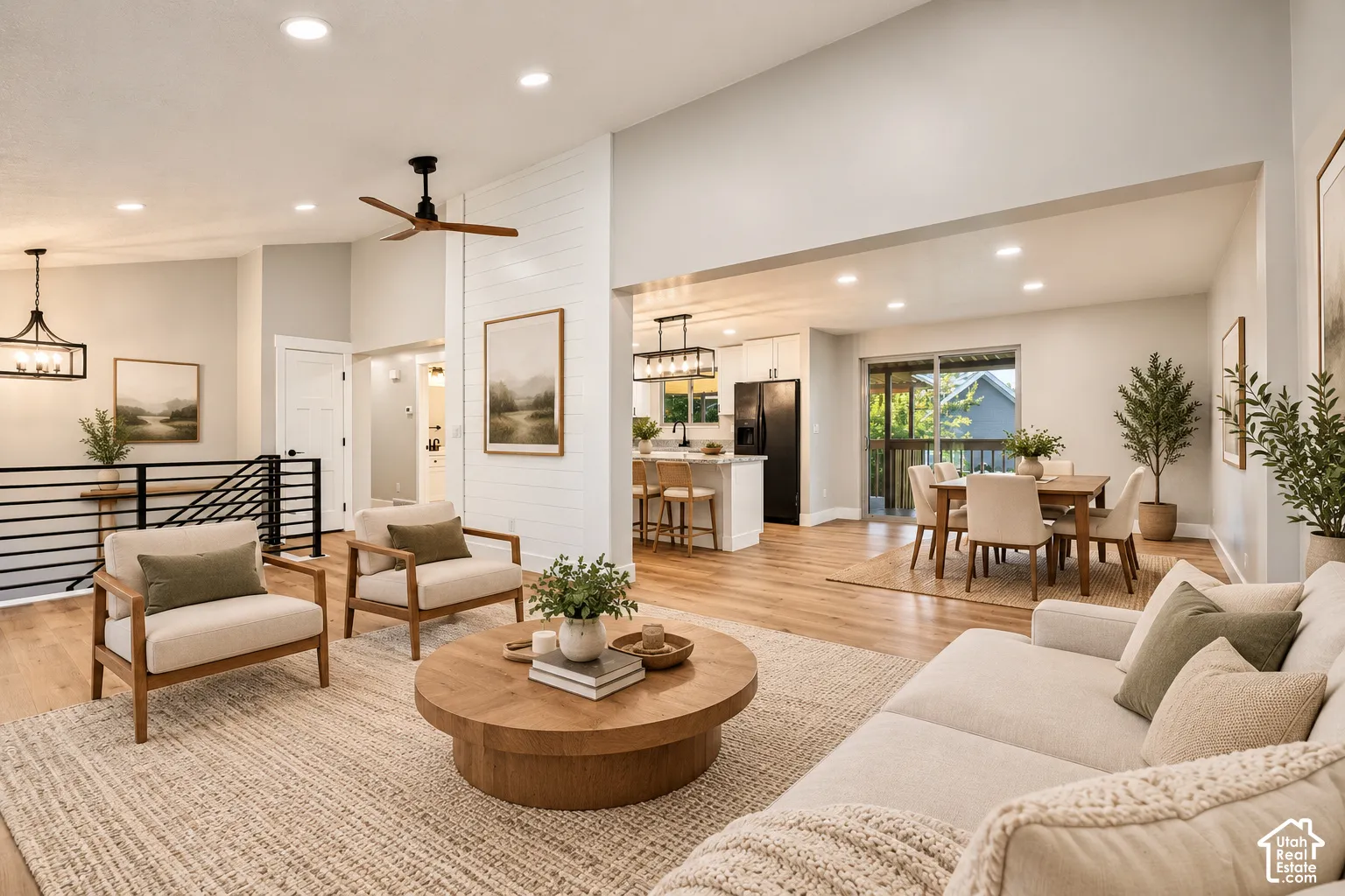 Open-concept living space featuring wood-finish flooring, recessed lighting, and a modern ceiling fan