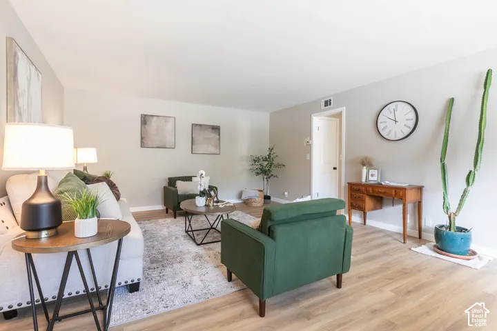 Light-toned walls, wood-finish flooring, and a white door with dark hardware