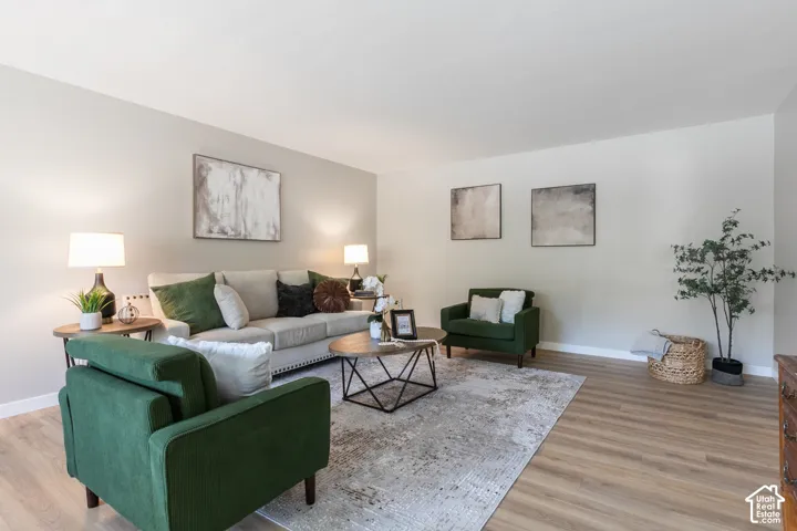 Light-toned walls, wood-finish flooring, and recessed lighting contribute to the bright interior