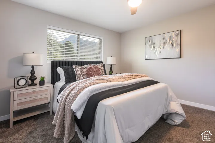 Wall-to-wall carpeting, window with blinds, ceiling fan with integrated lighting, and neutral wall tones
