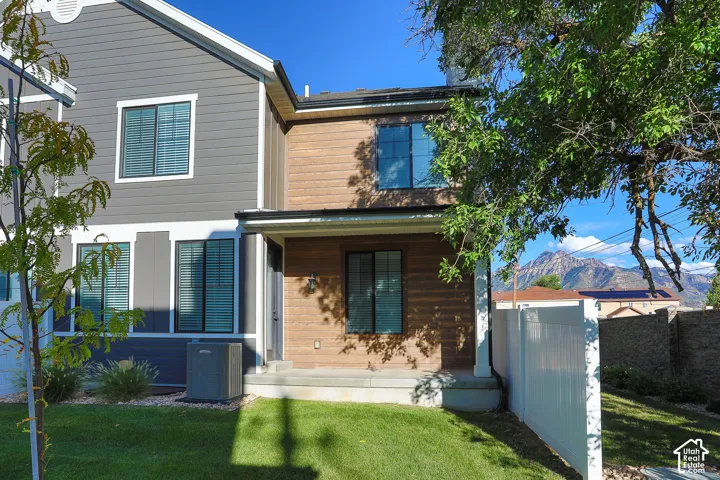 Two-story exterior with horizontal siding and wood-finish paneling