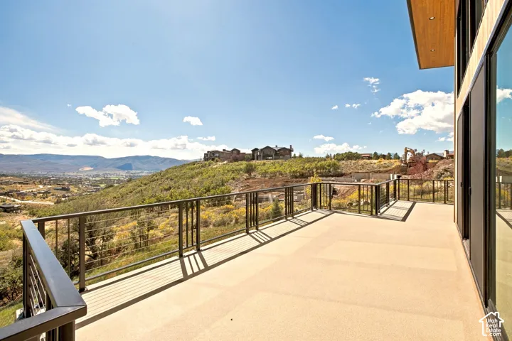 Expansive outdoor deck with cable railings and large format glass panels
