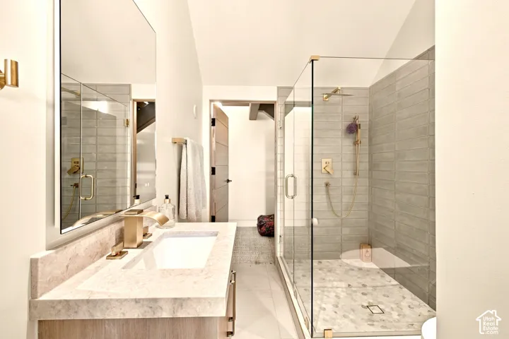 Walk-in glass shower with horizontal subway tile and hexagonal floor tile