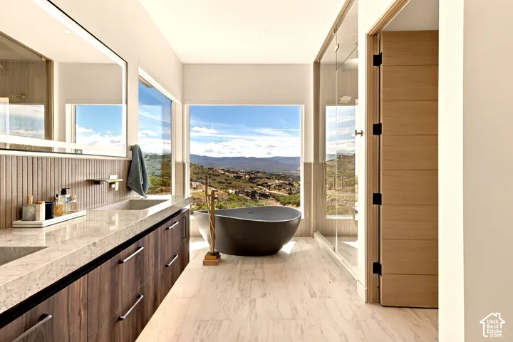 Dual vanity with wood-finish cabinetry, stone countertop, and integrated sinks