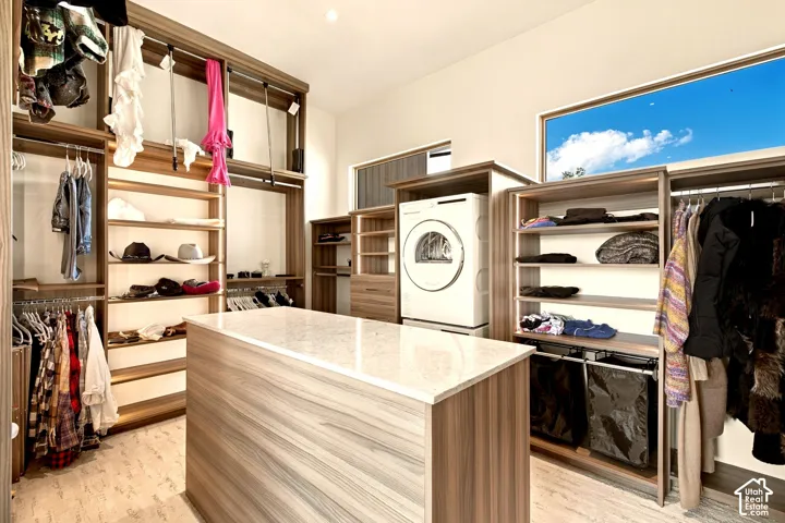 Custom closet system with wood-finish shelving and hanging rods