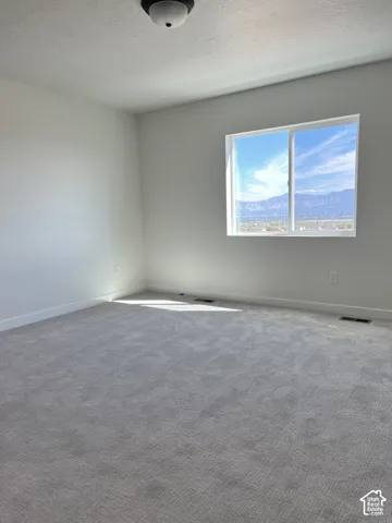 Light gray wall paint, recessed lighting fixture, double-pane window, wall-to-wall carpeting, white trim