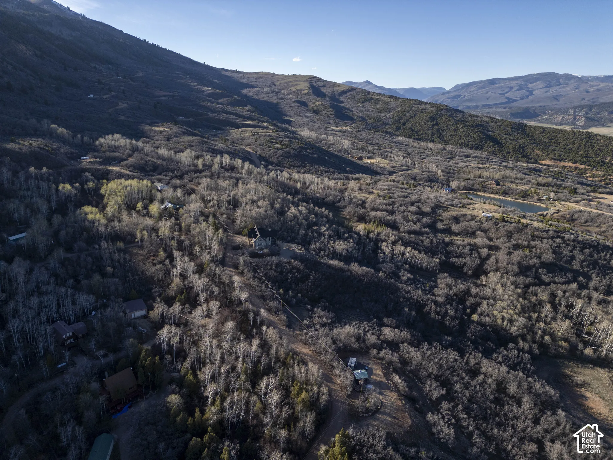 Expansive mountain landscape featuring varied terrain and scattered residences