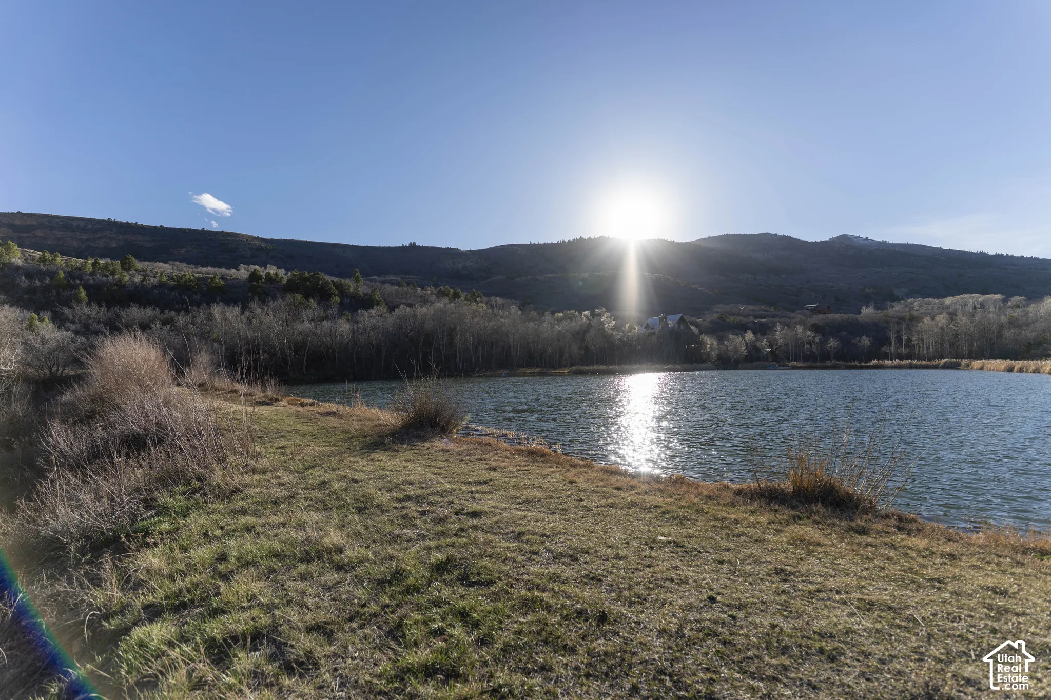 Waterfront property featuring a serene lake with mountain backdrop