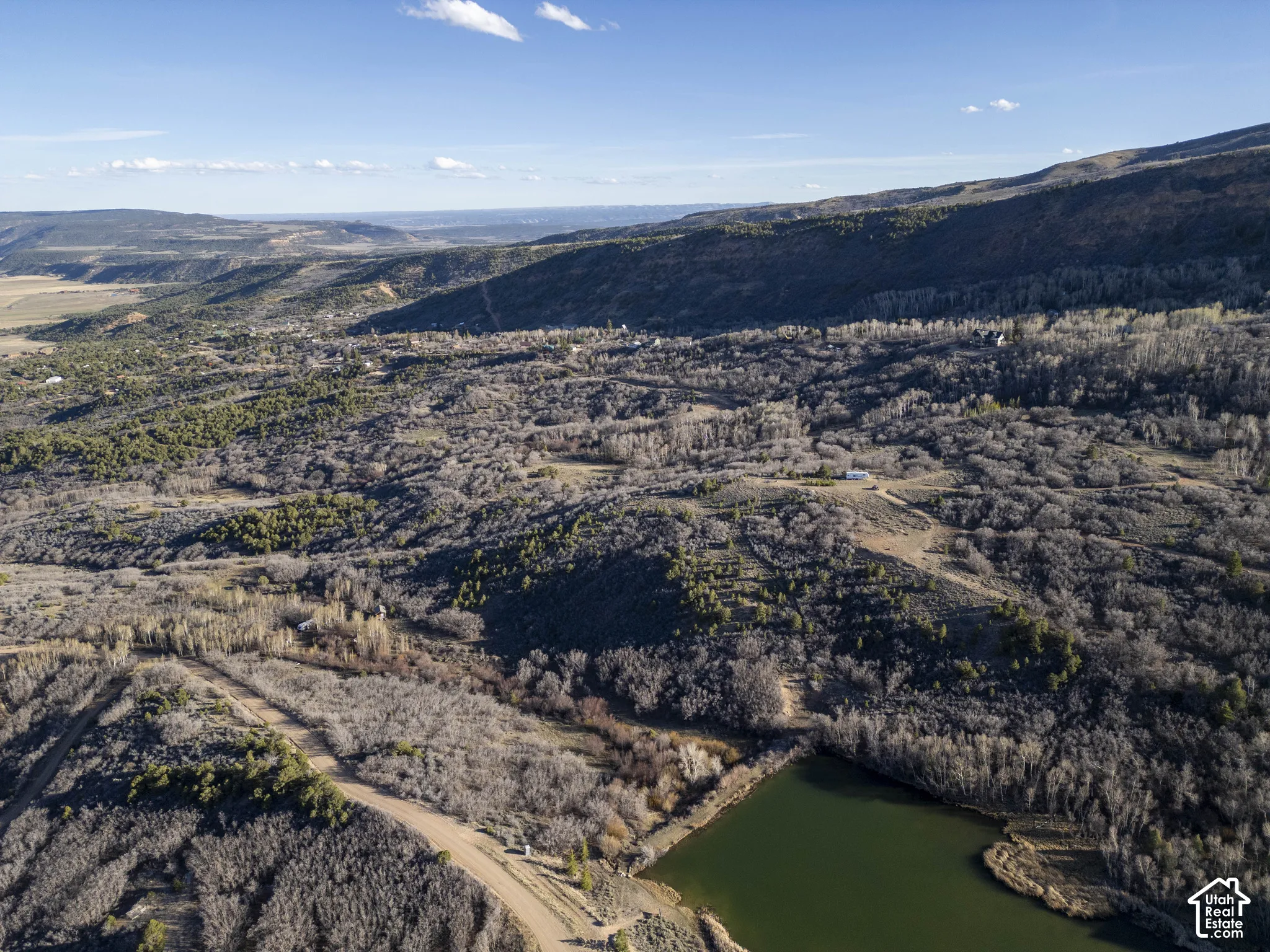 Expansive natural landscape with varied topography, including a body of water