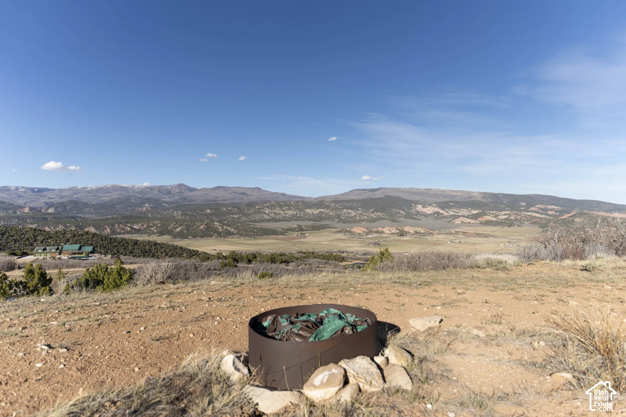 Expansive natural landscape with distant mountains and a permanent fire pit feature