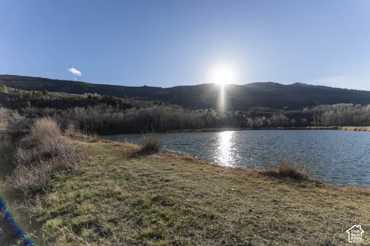 Waterfront property featuring a serene lake with mountain backdrop