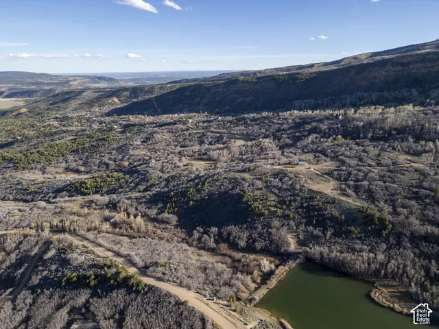 Expansive land with varied topography, including wooded areas and open clearings