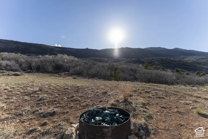 Expansive undeveloped land featuring natural terrain and distant mountain backdrop