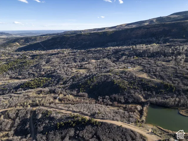 Expansive natural landscape featuring rolling hills and varied topography