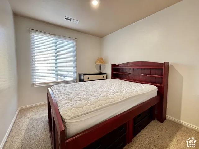 Carpeted flooring, recessed lighting, and a window with blinds