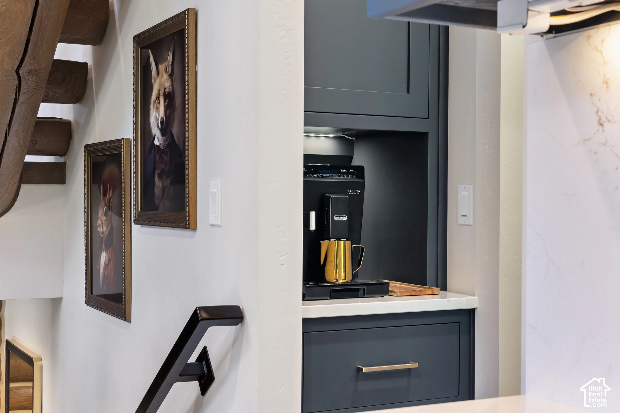 Built-in beverage station featuring custom cabinetry, integrated lighting, and a solid surface countertop
