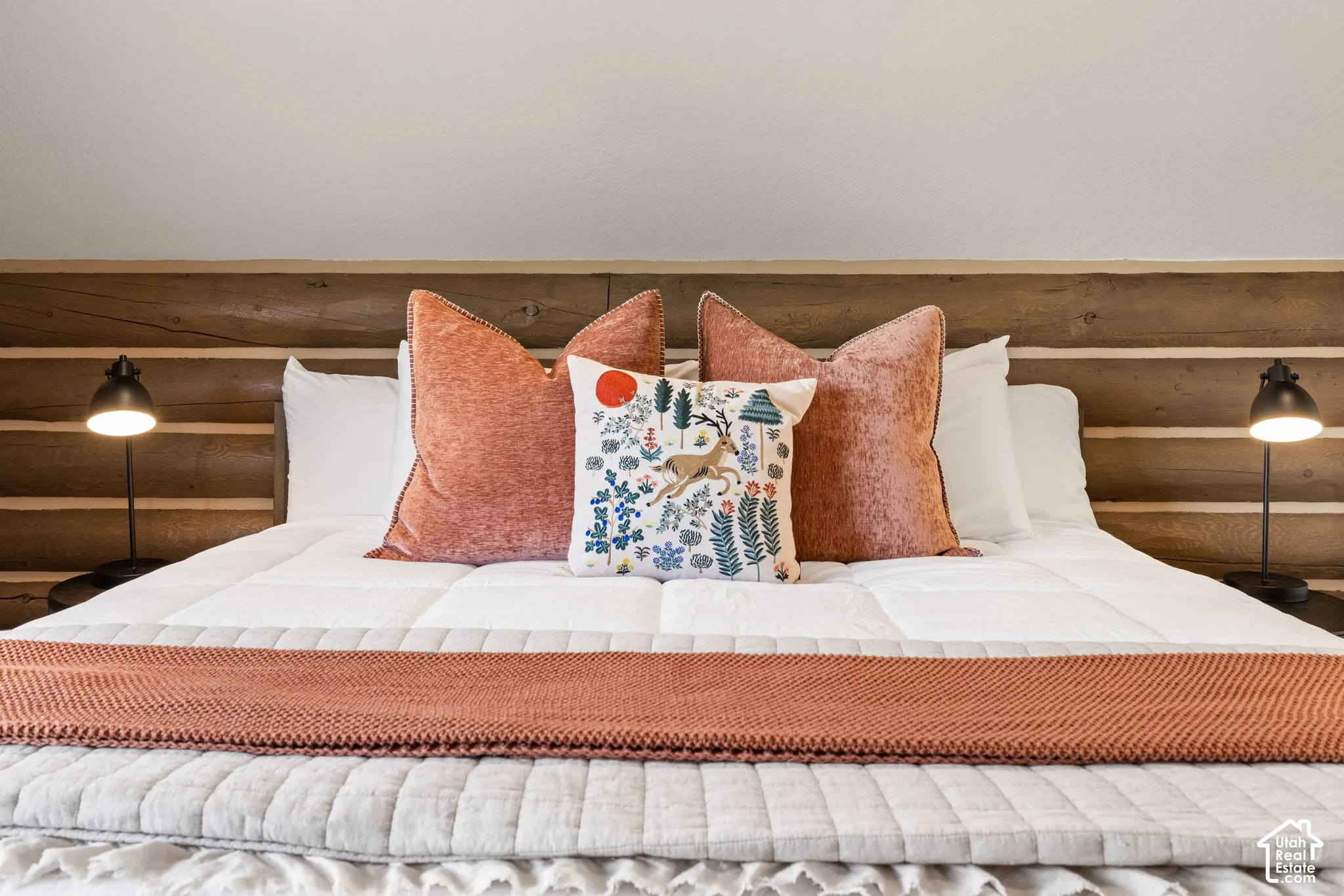 Wood-paneled headboard with integrated bedside lighting